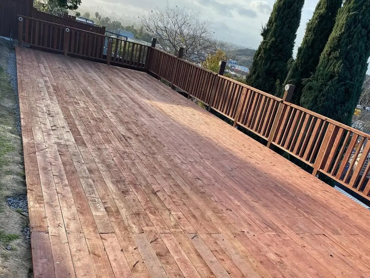 Large redwood deck with railing overlooking a San Diego hillside