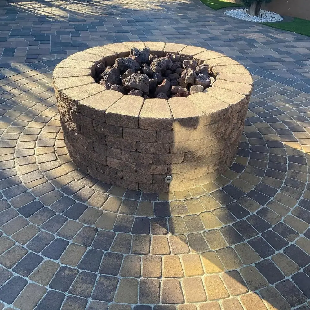 Circular paver patio in mixed charcoal and tan tones
